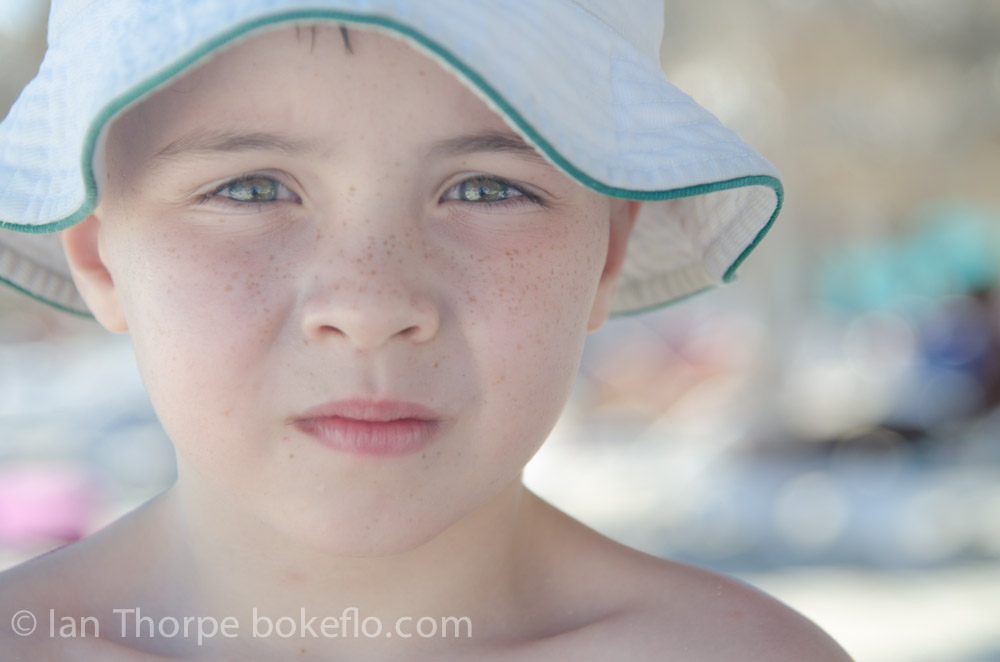 A closeup photo of boy with a hat on Varadero Beach, Cuba