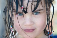 A closeup image of a young girl with braids on Varadero Beach, Cuba