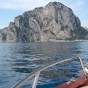 Private boat cruising though the Mediterranean Sea towards the Island of Capri from the coastal town of Sorrento in Italy