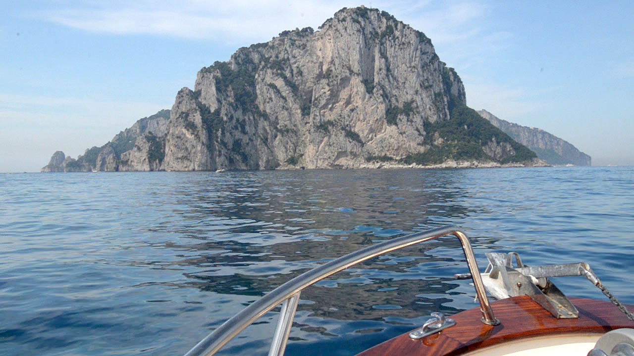 Private boat cruising though the Mediterranean Sea towards the Island of Capri from the coastal town of Sorrento in Italy