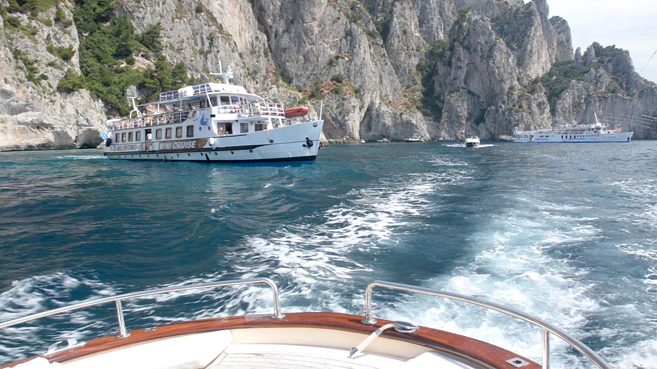 A private boat from Sorrento cruising along the coast of the Island of Capri in Italy