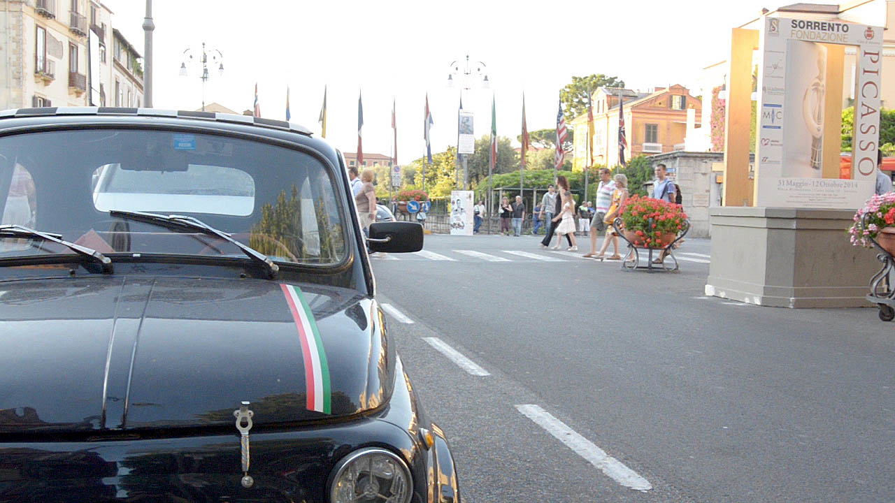An Original Fiat 500 car parket on a main street in the seaside town of Sorrento Italy
