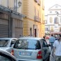 People walking amongst the cars on a narrow street in Sorrento Italy
