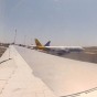 GoPro Time Lapse photograph from inside a airplane looking out over the wing and other airplanes taxiing towards the runway to take off at Leonardo Da Vinci Fiumicino Airport Rome Italy