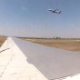 GoPro Time Lapse photograph from inside a airplane looking out over the wing at other airplanes taxing off as it wait to taxi towards the runway at Leonardo Da Vinci Fiumicino Airport Rome Italy