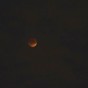 A frame of the Supermoon Lunar Eclipse of September 27 2015. at the red moon or blood moon stage, with some clouds obscuring the view.
