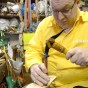 Shoe Maker in Sorrento Italy hammering a notch in the soul of a pair of Custom hand made Italian leather sandals