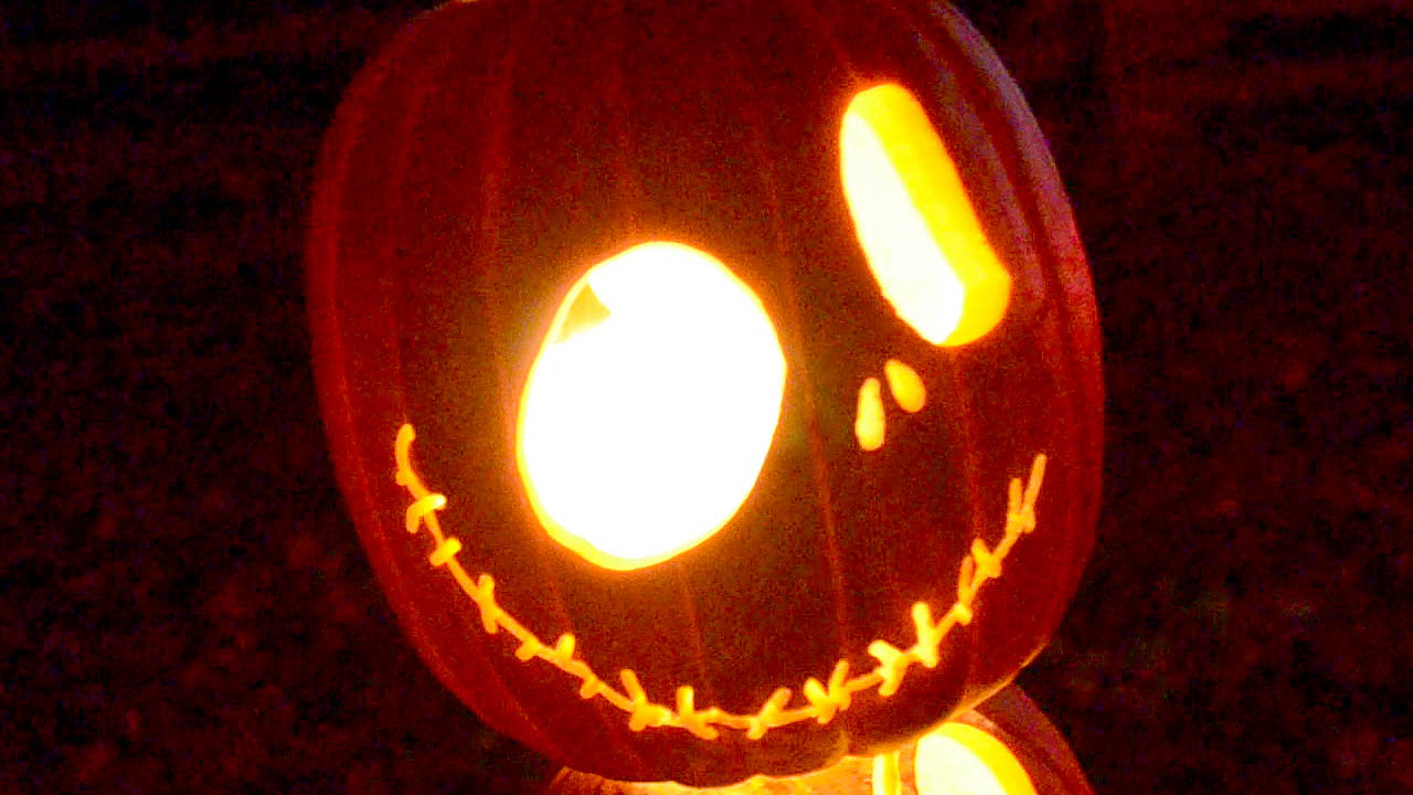 The photograph shows a pumpkin carved into a Jack-O-lantern similar in appearance to Jack in the movie Nightmare Before Christmas.