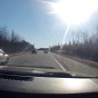 The photograph is a view through the windsheild the GoPro Hero 4 Black camera is mounts to with the GoPro suction cup, outward of the highway with some other cars on the way to Montreal.